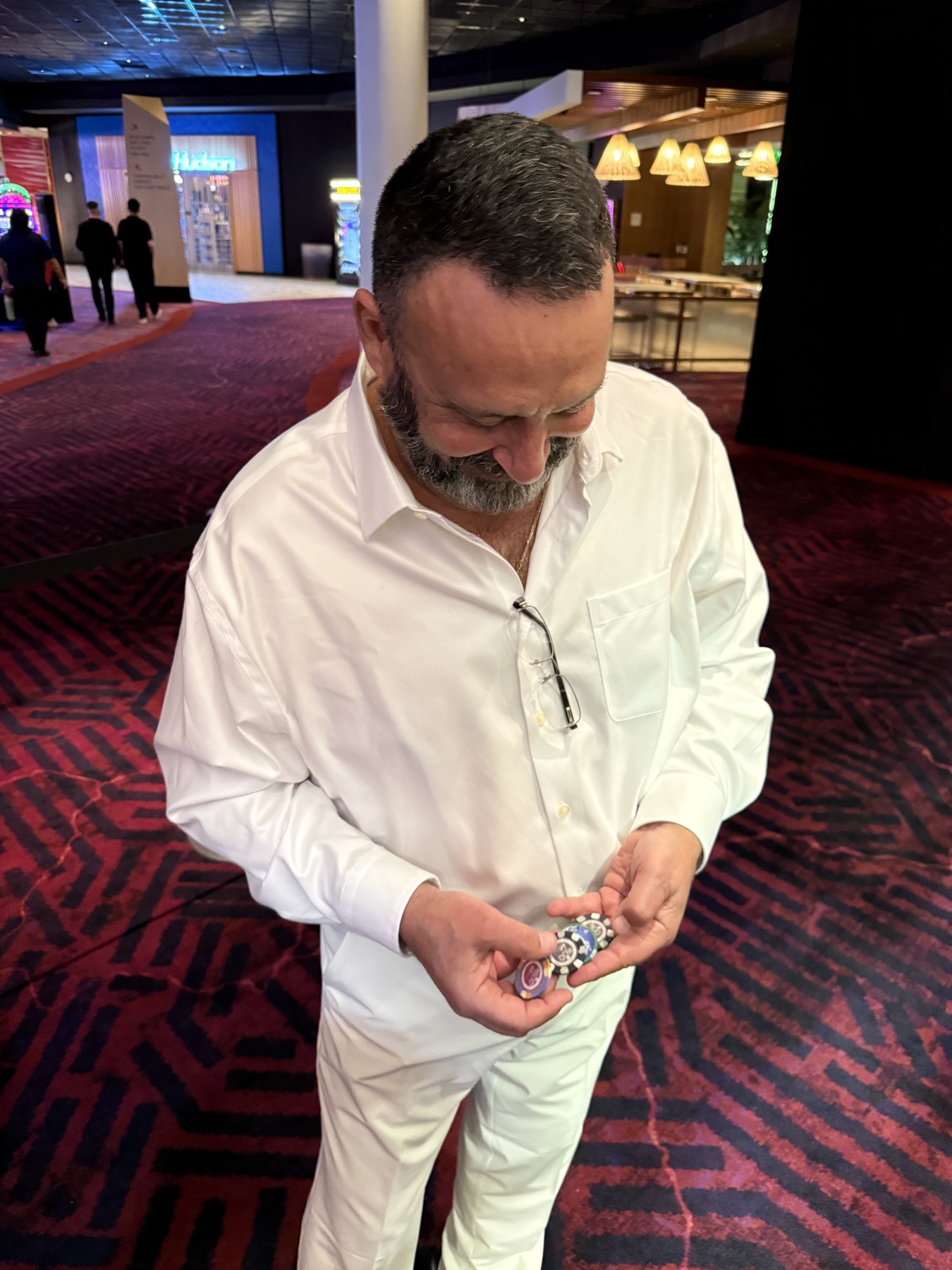 Sababa holding a colorful stack of casino chips