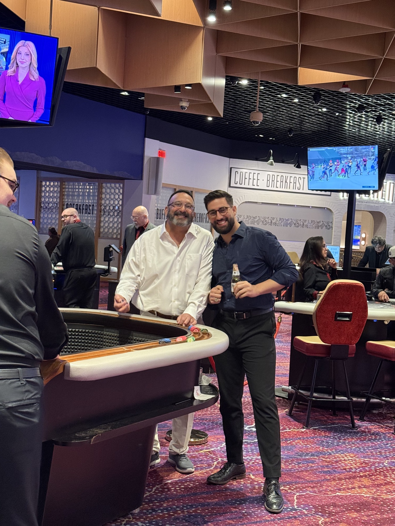Sababa smiling beside family at a casino table