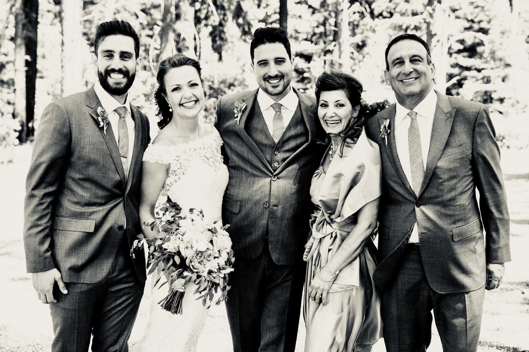 Sababa smiling with family at a wedding