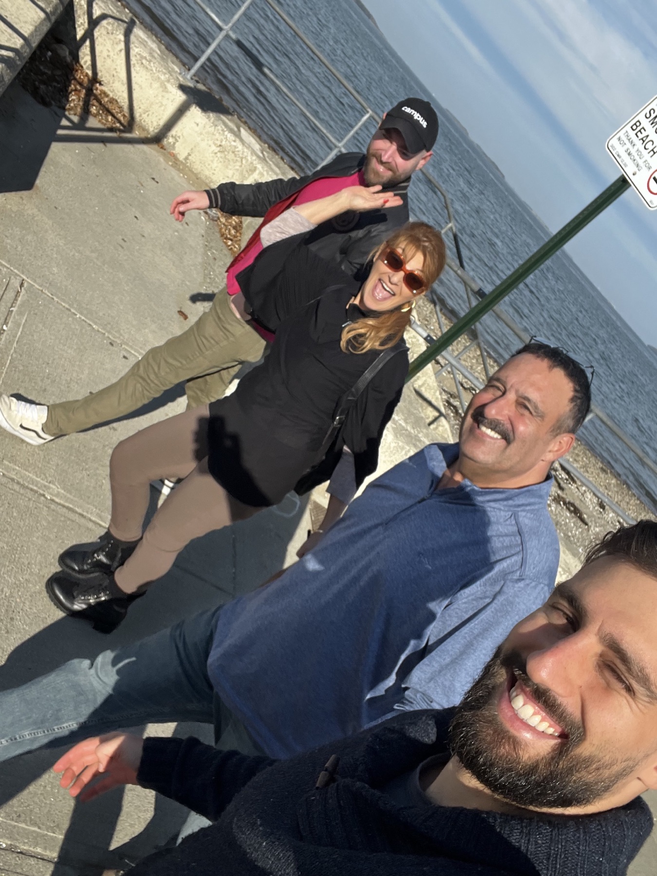 Alan and family laughing together beside the water