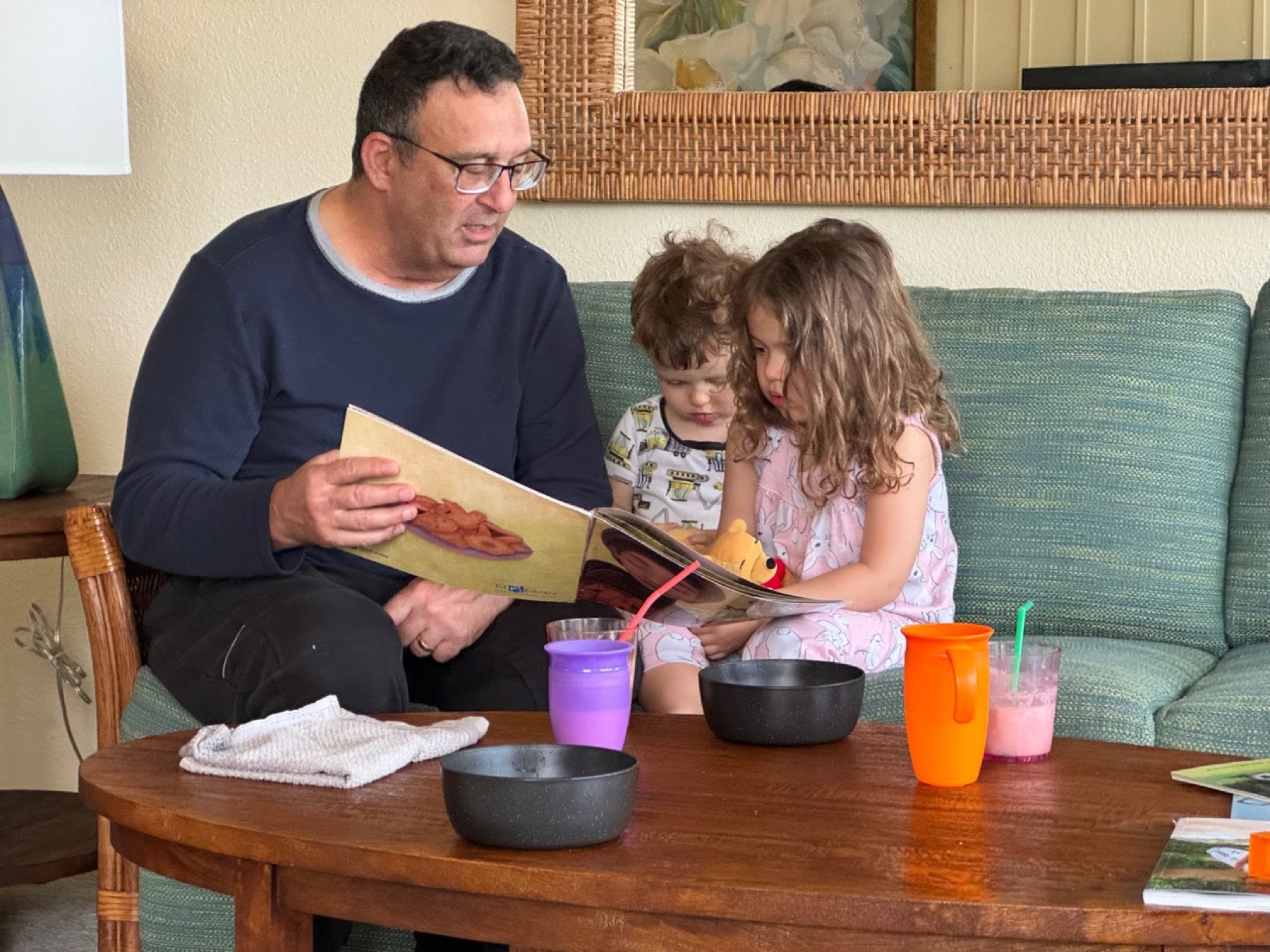 Alan reading a picture book with two young children